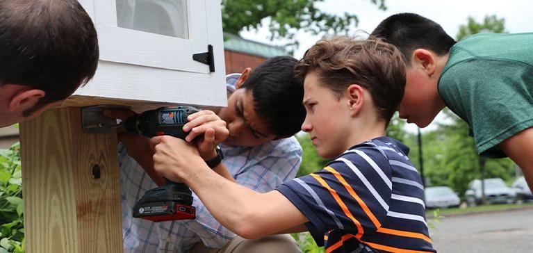 Chase Collegiate Middle School student's building together